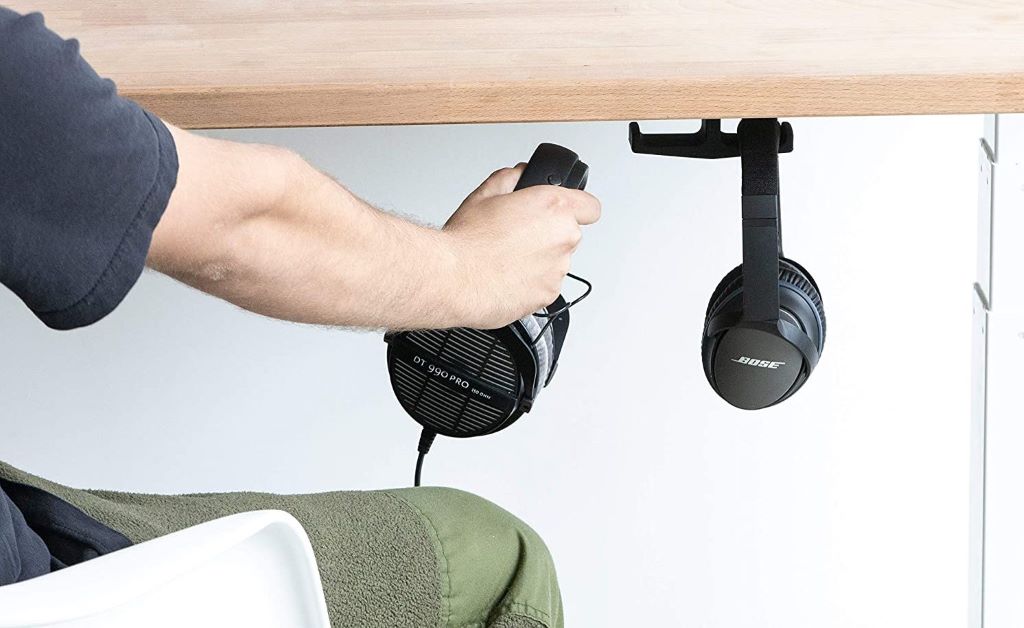 Gaming desk setup organized with a headset holder and clean cable management