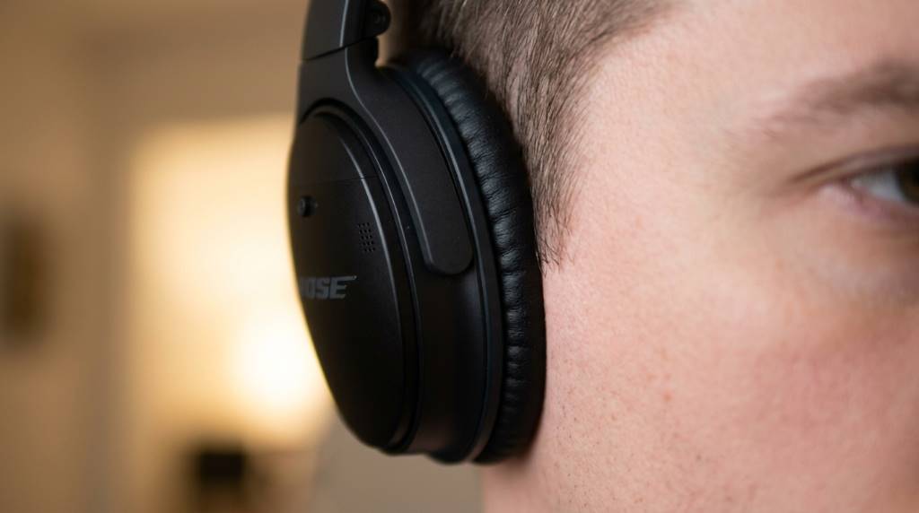 Person adjusting EQ settings on Bose Music app for headphones