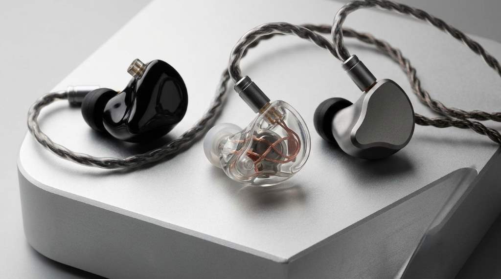 Person comparing different IEM headphones before buying